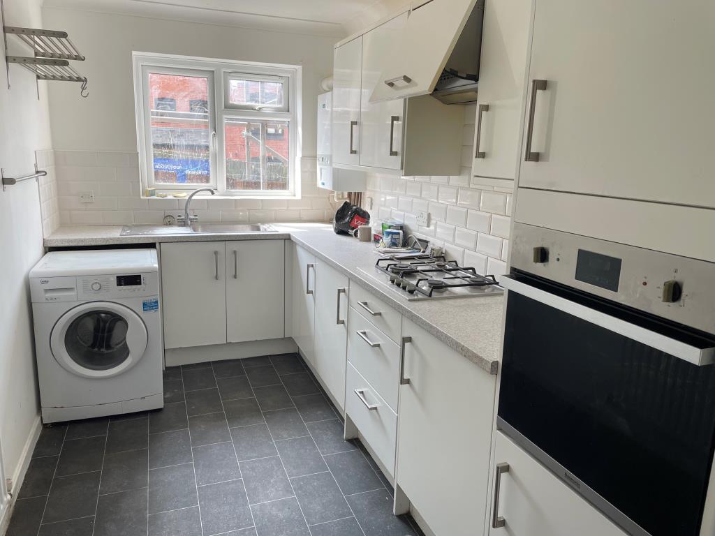 Lot: 151 - TWO-BEDROOM FLAT WITH PARKING - rear kitchen with fitted units and window to side